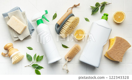 Eco friendly cleaning products promoting sustainable lifestyle on white tiles 122343328
