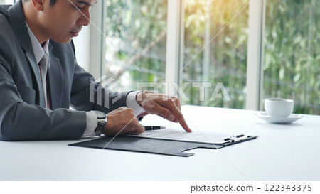 Businessman hands note meeting document in conference room. man Hands writing planning notebook. Close up male hand holding pencil write on diary sketchbook at office desk. Business Planning Concept 122343375