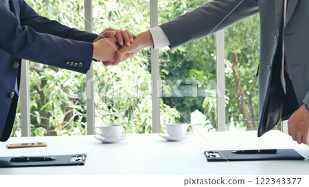Team Business Partners shaking hands together to Greeting Start up new project. Shakehand Teamwork Partnership at office desk. Businessman partners handshake together.  Business concept 122343377