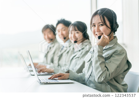 Customer support/help desk operator team of male and female staff (reassuring, responsive, phone support) Customer support/help desk operator team of male and female staff (reassuring, responsive, phone support) 122343537