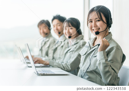 Customer support/help desk operator team of male and female staff (reassuring, responsive, phone support) 122343538