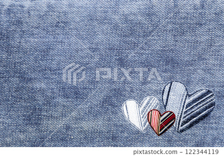 Light blue denim background with felt heart. Horizontal blue color denim jeans fabric texture with heart-shaped textile patch. Valentine's day denim backdrop. Copy space for text 122344119