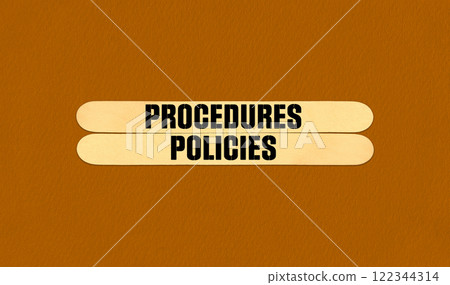 Concept word Procedures and Policies on beautiful wooden stick. Beautiful Orange Chart Paper Background. Business and Procedures and Policies concept. Copy space Concept word Procedures and Policies on beautiful wooden stick. Beautiful Orange Chart Paper Background. Business and Procedures and Policies concept. Copy space 122344314