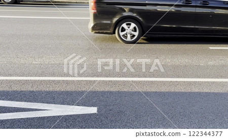 SUV driving through busy city traffic during rush hour. Dynamic urban scene with moving vehicles, sunlight on the road, energy-efficient commuting, and modern mobility. 122344377