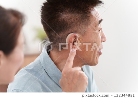 Senior man talking with a hearing aid 122344981