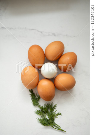Vibrantly Fresh Eggs Artistically Arranged in a Beautiful Floral Pattern Adorned with Herbs 122345102