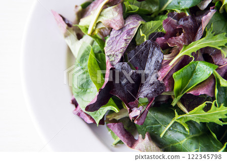 Baby leaves on a white plate Baby leaves on a white plate 122345798