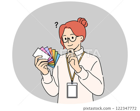 Woman designer holds palette of cards of different colors, choosing desired shade to use in design 122347772