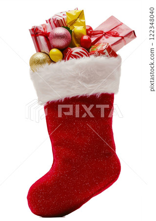 A red and white Christmas stocking filled with small gifts , candy poking out from the top. 122348040