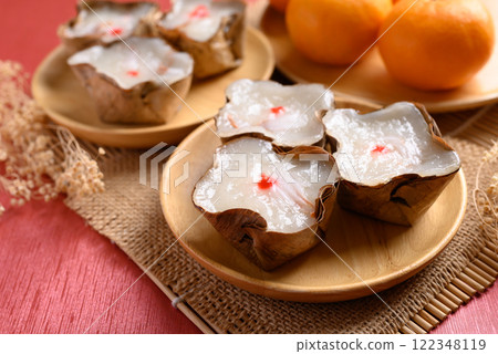 Sticky rice cake with coconut filling on red background, Chinese New Year cake Sticky rice cake with coconut filling on red background, Chinese New Year cake 122348119