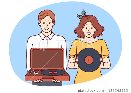Happy couple with turntable and vinyl record invites you to retro party with jazz music. 122348313