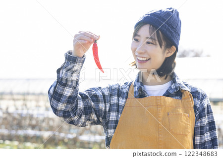 Woman with chili pepper 122348683