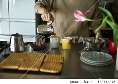 Drip coffee being poured into a cup Drip coffee being poured into a cup 122348856