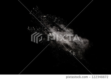 White powder explosion isolated on black background.White dust particles splash. White powder explosion isolated on black background.White dust particles splash. 122348872