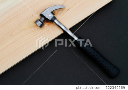 Hammer and lumber on a black background 122349269