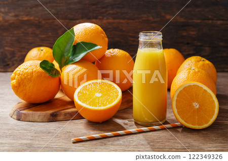 bottle of fresh orange juice with fresh fruits bottle of fresh orange juice with fresh fruits 122349326