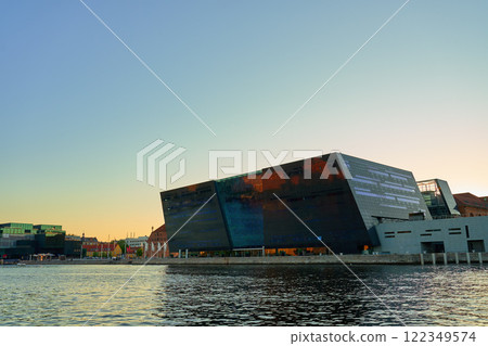 Exterior of Royal Library in Copenhagen. Facade of national library of Denmark known as the Black Diamond at sunset. Modern architecture in city 122349574