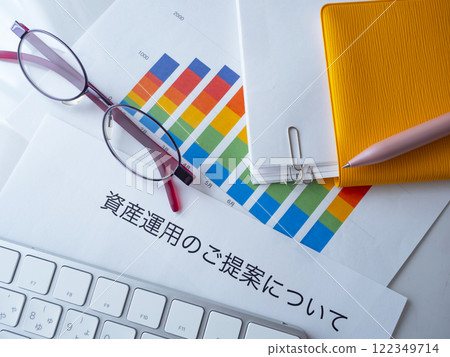 Graphs, keyboard, glasses, documents and notebook on the table 122349714