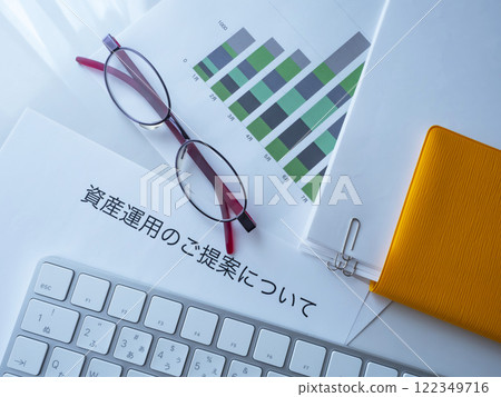 Graphs, keyboard, glasses, documents and notebook on the table 122349716