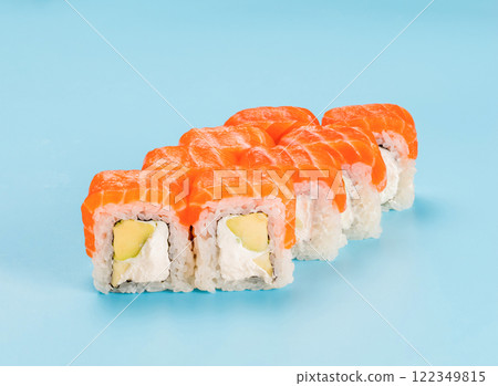 Studio photography of Philadelphia Roll of velvety cream cheese, and avocado, wrapped in perfect seasoned sushi rice and fresh salmon. Isolated on solid light blue background Studio photography of Philadelphia Roll of velvety cream cheese, and avocado, wrapped in perfect seasoned sushi rice and fresh salmon. Isolated on solid light blue background 122349815