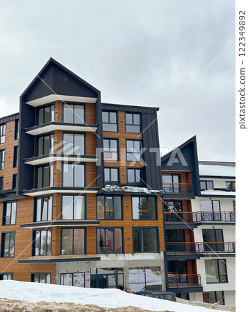 New modern block of flats in green area at winter. residential apartment with flat buildings exterior. luxury house complex covered snow. City Real estate property condo architecture insurance concept New modern block of flats in green area at winter. residential apartment with flat buildings exterior. luxury house complex covered snow. City Real estate property condo architecture insurance concept 122349892