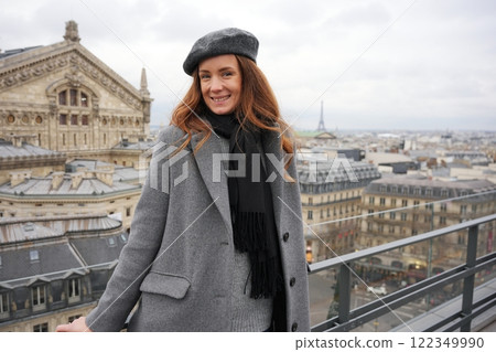 Smiling Woman in Paris on Rooftop with Iconic Eiffel Tower View  122349990
