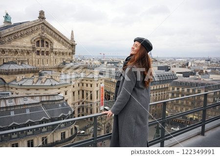 Smiling Woman Enjoying Paris Rooftop View  122349991