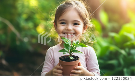 Smiling Girl Holding a Potted Plant in a Sunny Garden 122350024