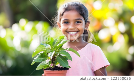Smiling Girl Holding a Potted Plant in a Colorful Outdoor Garden 122350026