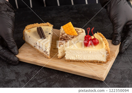 classic cheesecake decorated with cherries, chocolate and cookies on a dark background 122350094
