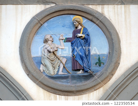Works of Mercy, glazed terracotta tondo by Andrea della Robbia, located between two arches of the old Ospedale di San Paolo, in Florence, Italy Works of Mercy, glazed terracotta tondo by Andrea della Robbia, located between two arches of the old Ospedale di San Paolo, in Florence, Italy 122350534