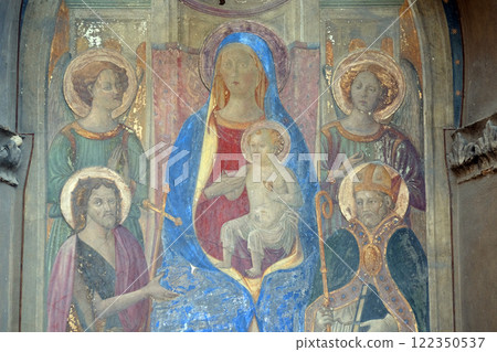 Madonna Enthroned with Saints and Angels, fresco by Francesco Fiorentino, corner of Via della Scala and Piazza Santa Maria Novella in 1420, in Florence, Italy 122350537