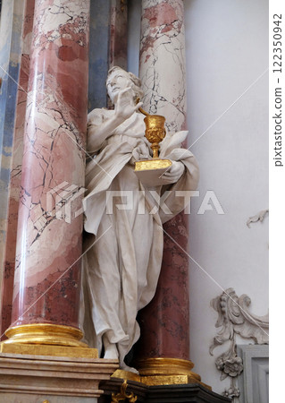 Saint John the Evangelist statue on the altar in Benedictine monastery church in Amorbach, Germany 122350942
