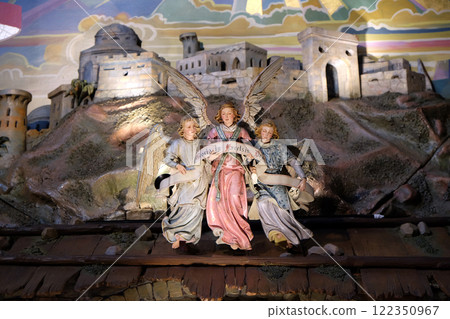 Angel with Gloria in excelsis Deo Banner, Nativity Scene in Franciscan Church in Graz, Styria, Austria Angel with Gloria in excelsis Deo Banner, Nativity Scene in Franciscan Church in Graz, Styria, Austria 122350967