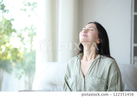 Asian woman breathing fresh air at home 122351456
