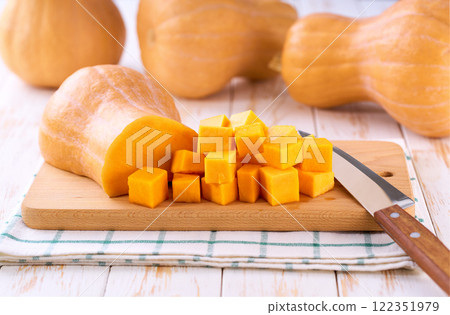Diced butternut squash on wooden cutting board, selective focus. Diced butternut squash on wooden cutting board, selective focus. 122351979