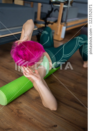 Discover the benefits of Pilates with a Foam Roller in a modern and inviting studio Discover the benefits of Pilates with a Foam Roller in a modern and inviting studio 122352071