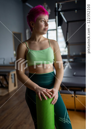 The Dynamic Fitness Model in a Studio showcasing Pilates and Wellness practices and activities The Dynamic Fitness Model in a Studio showcasing Pilates and Wellness practices and activities 122352108