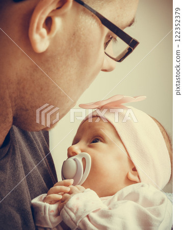 Father holding delicate his newborn baby. 122352379