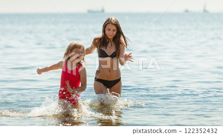 Little girl kid and woman mother in sea water. Fun Little girl kid and woman mother in sea water. Fun 122352432