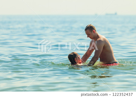Little girl kid and man father in sea water. Fun Little girl kid and man father in sea water. Fun 122352437