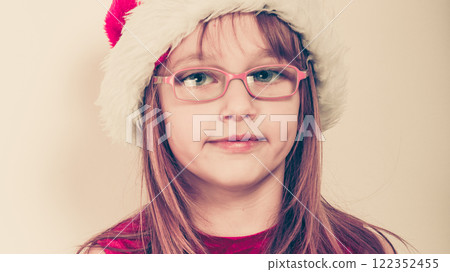 Little girl looking like santa elf. 122352455