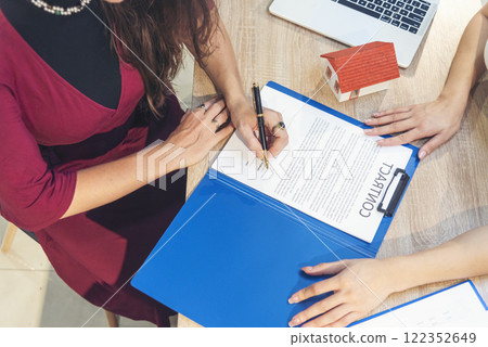 Close up Team Businesswoman hands partners sign contract with success business deal. Diversity Businesswoman teams handshake together. Partnership teamwork meeting signing contract business concept 122352649