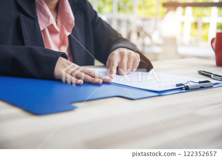 Close up businesswoman hands manager signing reading business contract document. Businesspeople hand use pen signing contract start up small projects in conference room. Business agreement concepts Close up businesswoman hands manager signing reading business contract document. Businesspeople hand use pen signing contract start up small projects in conference room. Business agreement concepts 122352657