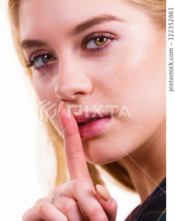 Woman showing silence gesture Woman showing silence gesture 122352861
