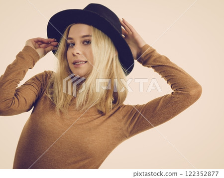 Woman wearing suede and black hat 122352877