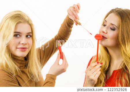 Two women and lip product Two women and lip product 122352926