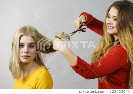 Woman with scissors ready to hair cutting 122352943
