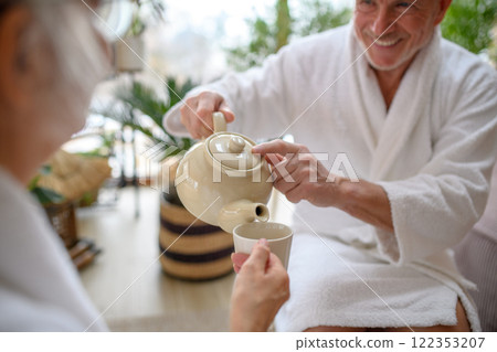Cup of tea after a spa session. Seniors sitting in a relaxation room. Cup of tea after a spa session. Seniors sitting in a relaxation room. 122353207