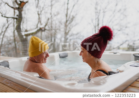 Senior couple couple using a hot tub. Concept of Valentine's weekend getaway. 122353223